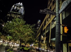 A peek into the the city life in Austin, Texas. A picture of the 6th St. and Congress St. intersection with the Frost Bank Tower in the background.